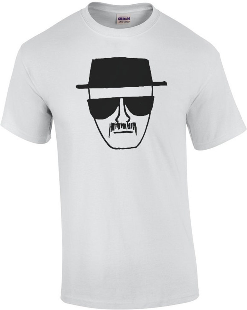 May include: White t-shirt with a black and white line drawing of Walter White's face from the TV show Breaking Bad.