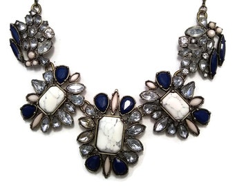 Gold Tone Vintage Bib Necklace with White, Clear and Blue Plastic Resin Stones.