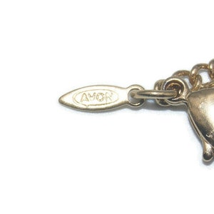 May include: Gold-toned chain necklace with a lobster clasp fastening. The tag on the necklace reads "AVON".