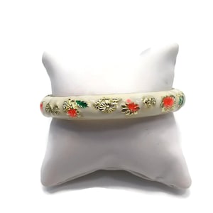 Vintage gold tone enameled floral motif hinged 7 Inch bangle bracelet. White, orange and green enamel.