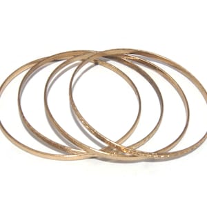 4 Vintage Textured Gold Tone 8 Inch Stacking Bangle Bracelets.
