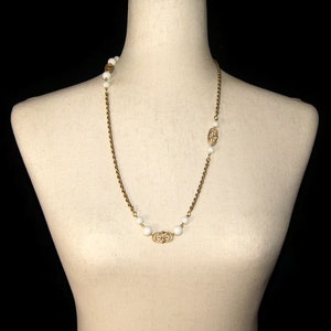 Vintage Asymmetrical Gold Tone and White Plastic Beaded 27 Inch Link Necklace with Gold Spring Ring Clasp.