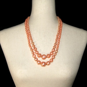 Vintage Gold Tone and Peach Plastic 24 Inch 2 Strand Beaded Necklace with Hook Clasp.