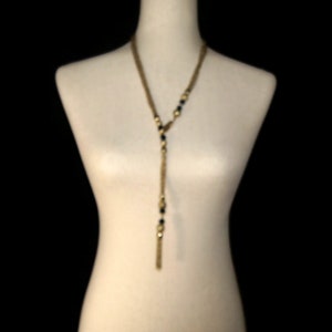 Vintage Gold Tone and Black Plastic Beads 32 Inch Lariat Necklace with Hook Clasp.