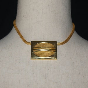 Vintage Gold Tone Rectangular Pendant on 14 to 16 Inch Adjustable Gold Tone Mesh Chain with Spring Ring Clasp.