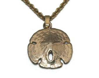 Vintage Gold Tone Sand Dollar Pendant on 18 Inch Chain with Lobster Claw Clasp.