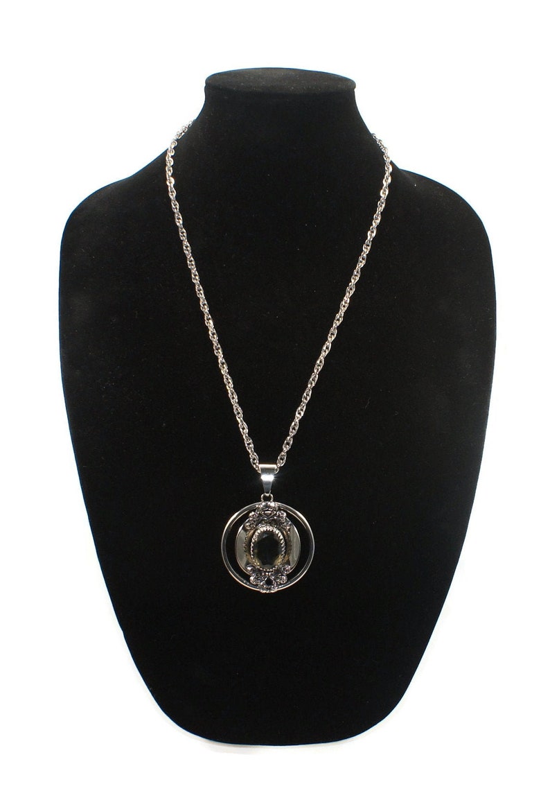 Vintage Southwestern Style Round Silver Tone Pendant with Faceted Faux Smoky Topaz on 24 Inch Silver Tone Chain with Spring Ring Clasp.