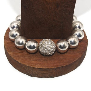 Vintage Silver Tone Plastic and Clear Rhinestones Beaded 7 Inch Elastic Bracelet.