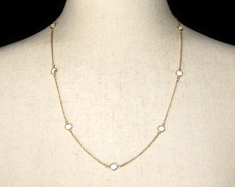 Radiant Vintage Gold Tone and Bevel Set Clear Crystals 22 1/2 Inch Necklace with a Spring Ring Clasp.