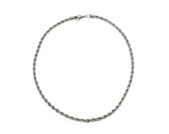 May include: A silver rope chain necklace with a lobster clasp.