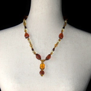 Vintage Orange, Yellow and Brown Glass Beaded 21 Inch Y Necklace with Gold Tone Toggle Clasp.