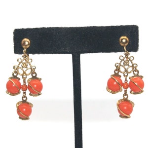Vintage Gold Tone and Caged Orange Plastic Beads Dangle Screw Back Earrings.