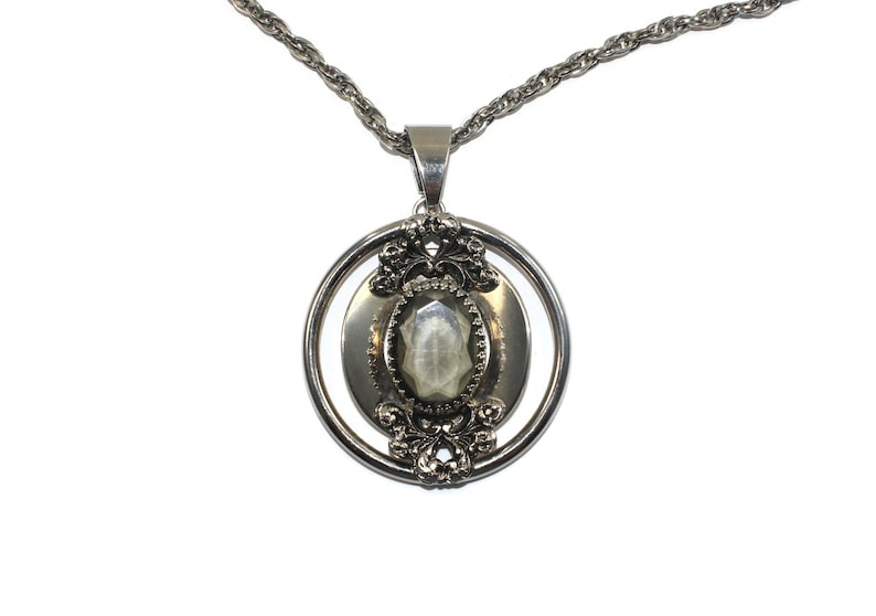 Vintage Southwestern Style Round Silver Tone Pendant with Faceted Faux Smoky Topaz on 24 Inch Silver Tone Chain with Spring Ring Clasp.