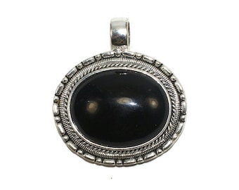 May include: A silver pendant with a black oval gemstone set in a decorative silver frame.