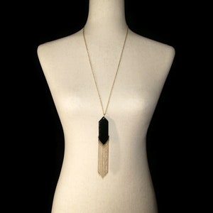 Vintage Gold Tone and Black Plastic Fringed Pendant on 28 Inch Gold Tone Chain with Lobster Claw Clasp.