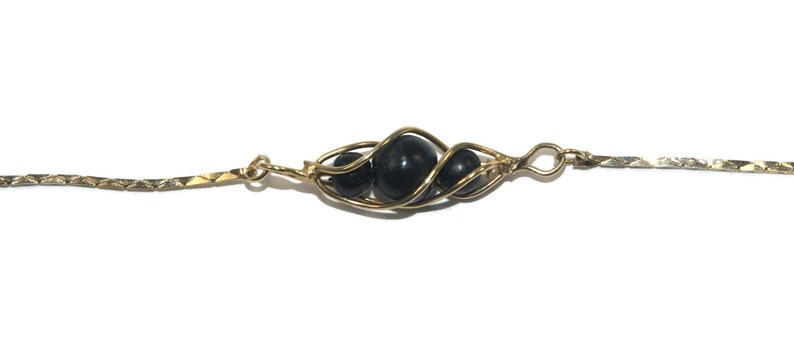 Vintage Gold Tone and Caged Black Beads 24 Inch Necklace with Spring Ring Clasp.