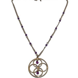 May include: A gold chain necklace with a circular pendant featuring an intricate design of overlapping circles. The pendant has three small purple gemstones.