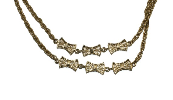 Vintage 48 inch long gold tone necklace with stationary bow tie links.
