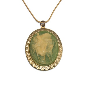 Vintage Gold Tone with Green Resin Roman Chariot with Woman Driver Oval Cameo Brooch on 18 Inch Gold Tone Chain with Lobster Claw Clasp.