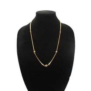 Collar vintage Avon oro tono de 24 pulgadas con cuentas de bola estacionaria con cierre de anillo de primavera. Etiqueta Avon Hallmark.
