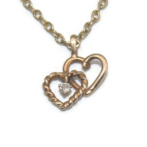 Vintage Dainty Double Heart and Single Clear Stone Pendant on a 15 Inch Gold Tone Chain with a Spring Ring Clasp.