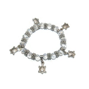 Vintage Silver Tone and Clear Crystal Beads 6 1/2 Inch Elastic Bracelet with Silver Tone Turtle Charms.