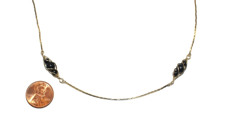 Vintage Gold Tone and Caged Black Beads 24 Inch Necklace with Spring Ring Clasp.