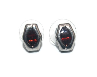 Pequeños pendientes vintage de tonos plateados y pedrería roja con respaldos de poste para orejas perforadas.