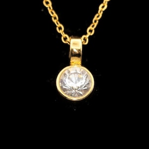 Vintage Gold Tone and Clear Rhinestone Pendant on 18 Inch Gold Tone Chain with Lobster Claw Clasp.