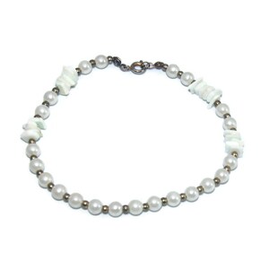 May include: A white pearl and shell bracelet with a silver clasp.