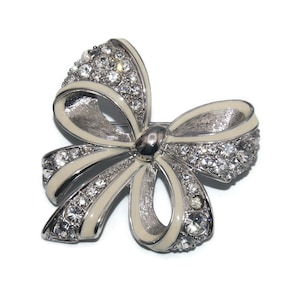 Vintage Nolan Miller Silver Tone, White Enamel and Clear Rhinestones Bow Brooch. Nolan Miller Hallmark.