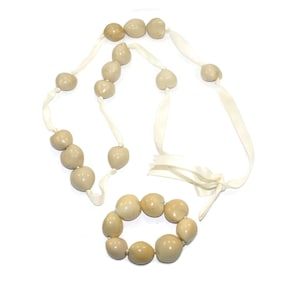 Chunky White Hawaiian Kukui Nut Necklace with White Ribbon Bow Closure with Matching Elastic Bracelet.