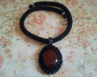 Black crocheted beaded necklace with carneol pendant, beadwork, crochet necklace, crocheted rope, karneol gemstone, beaded pendant