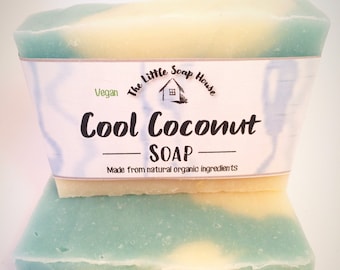 May include: Two bars of handmade soap with a light blue and white swirl design. The label reads "The Little Soap House", "Vegan", "Cool Coconut Soap", and "Made from natural organic ingredients".