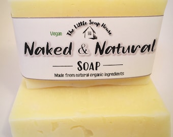 May include: Two bars of pale yellow soap with a white label that reads "The Little Soap House", "Vegan", "Naked & Natural", "SOAP", and "Made from natural organic ingredients".