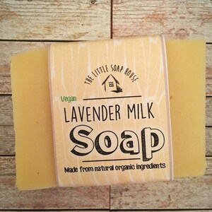 May include: A bar of yellow soap with a label that reads "The Little Soap House" and "Lavender Milk Soap" in black text. The label also says "Vegan" and "Made from natural organic ingredients".
