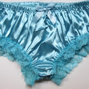May include: Light blue satin panties with a lace trim and a bow at the front.