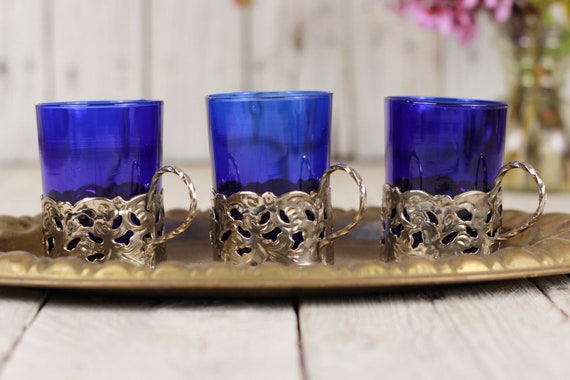 glass and metal tea cups