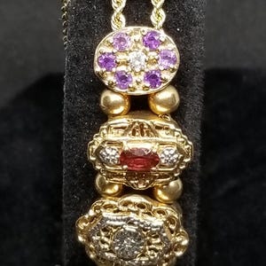 V0066 Vintage Richard Klein KLJCI 14K Yellow Gold Multi Stone Charm 7.5" Bracelet.
