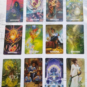 May include: A set of 10 tarot cards featuring colorful illustrations of various characters and symbols. The cards are arranged in two rows of five. The cards include Death, Temperance, The Tower, The Star, The Sun, Judgement, The World, Hope, Two of Pentacles, Three of Pentacles, Eight of Pentacles, Nine of Pentacles.