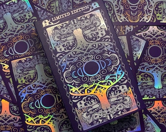 May include: A deck of cards with a holographic, iridescent finish. The box features a detailed illustration of a tree with a large moon in the center. The text "LIMITED EDITION" is printed on the box.