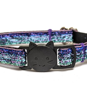 May include: A blue, green, and purple iridescent cat collar with a black plastic cat-shaped buckle.