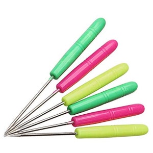 May include: Set of six colorful crochet hooks with metal tips. The hooks have green, pink, and yellow handles.
