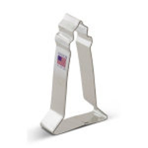 May include: Silver metal cookie cutter shaped like a lighthouse.