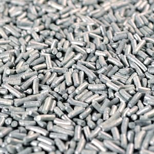 May include: Close-up of a pile of silver-colored sprinkles. The sprinkles are cylindrical with rounded ends, and they are scattered across the frame. The image is well-lit, highlighting the texture and color of the sprinkles.