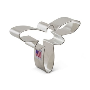 May include: A silver metal cookie cutter shaped like a dragonfly. The cutter is made in the USA.