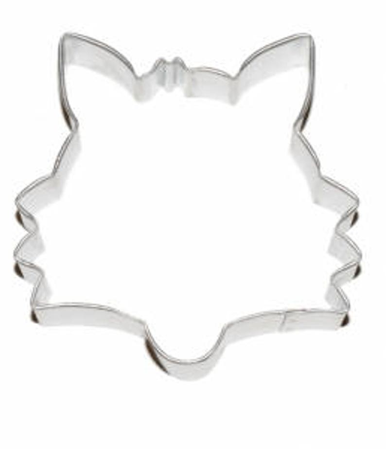 May include: A silver metal cookie cutter shaped like a fox's head.