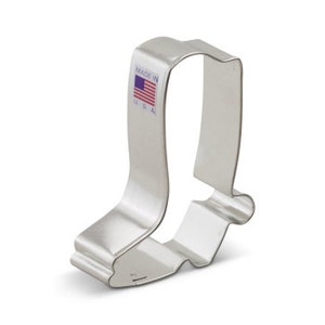 May include: Silver metal cookie cutter shaped like a cowboy boot.