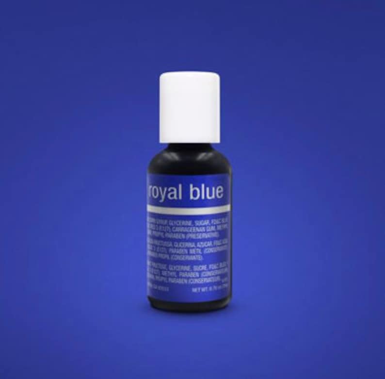 May include: A small bottle of royal blue food coloring. The bottle is labeled "Royal Blue" and has a white cap.