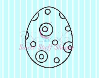 May include: Black and white line drawing of an Easter egg with a pattern of circles and dots.
